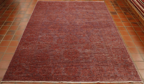 Purple red ground to the entirety of this rug with the decoration being floral executed in a blended red. 